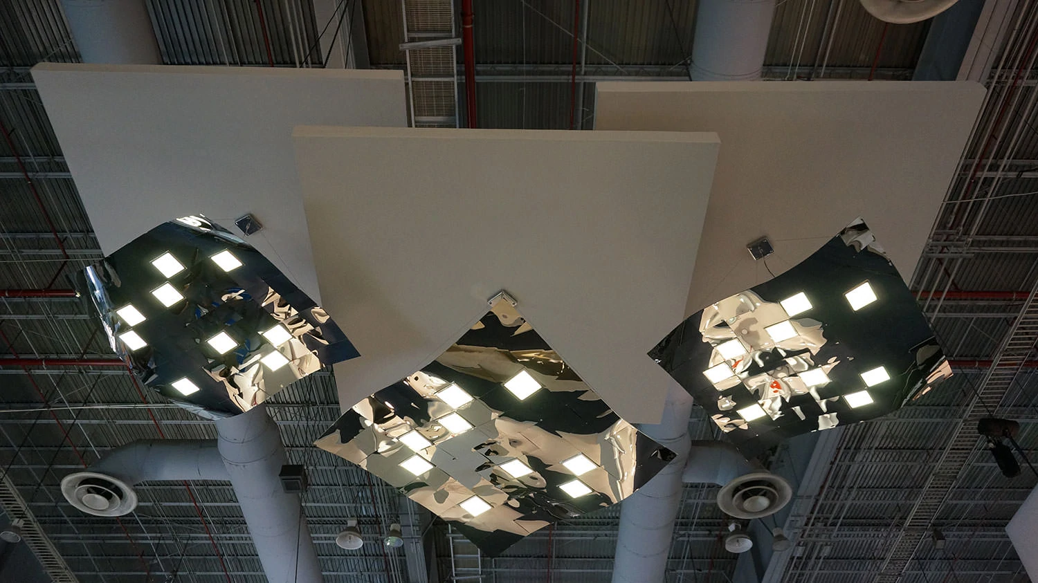 Three pendant OLED luminaires Pixelate hanging from a ceiling