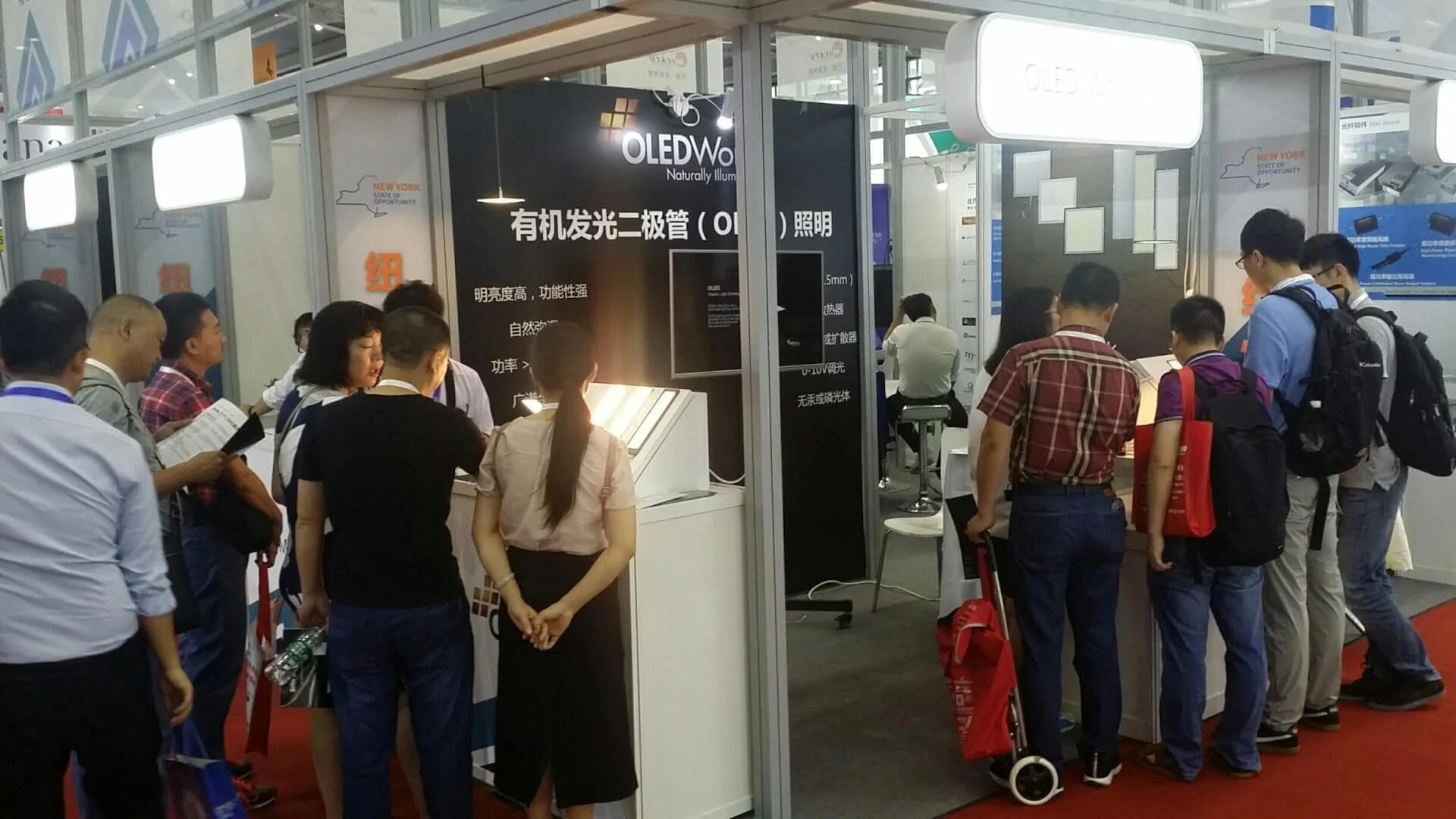 crowded OLEDWorks booth at CIOE in Shenzhen