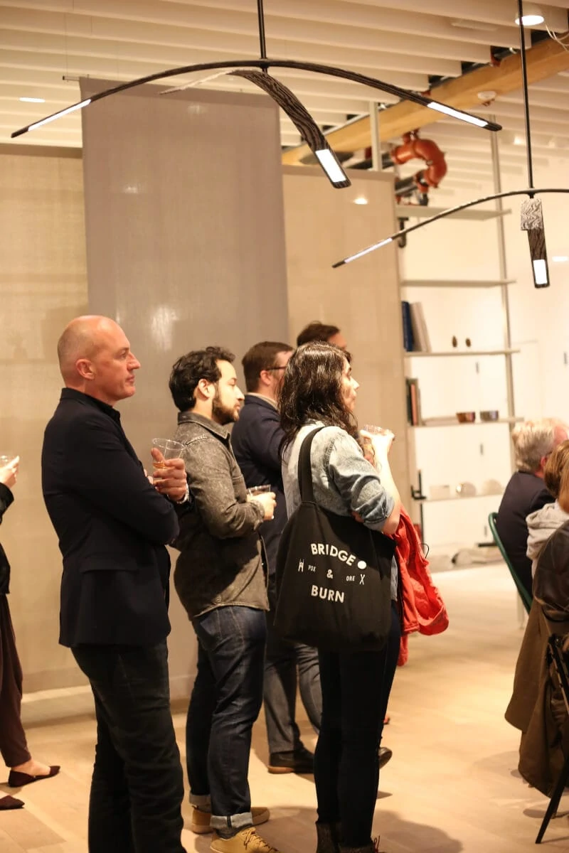 People listening to panel discussion under Rich Brilliant Willing´s OLED fixture “Light Inflection”