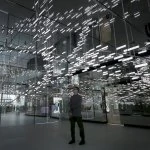 Man stands in the middle of OLED lighting installation Light Cloud