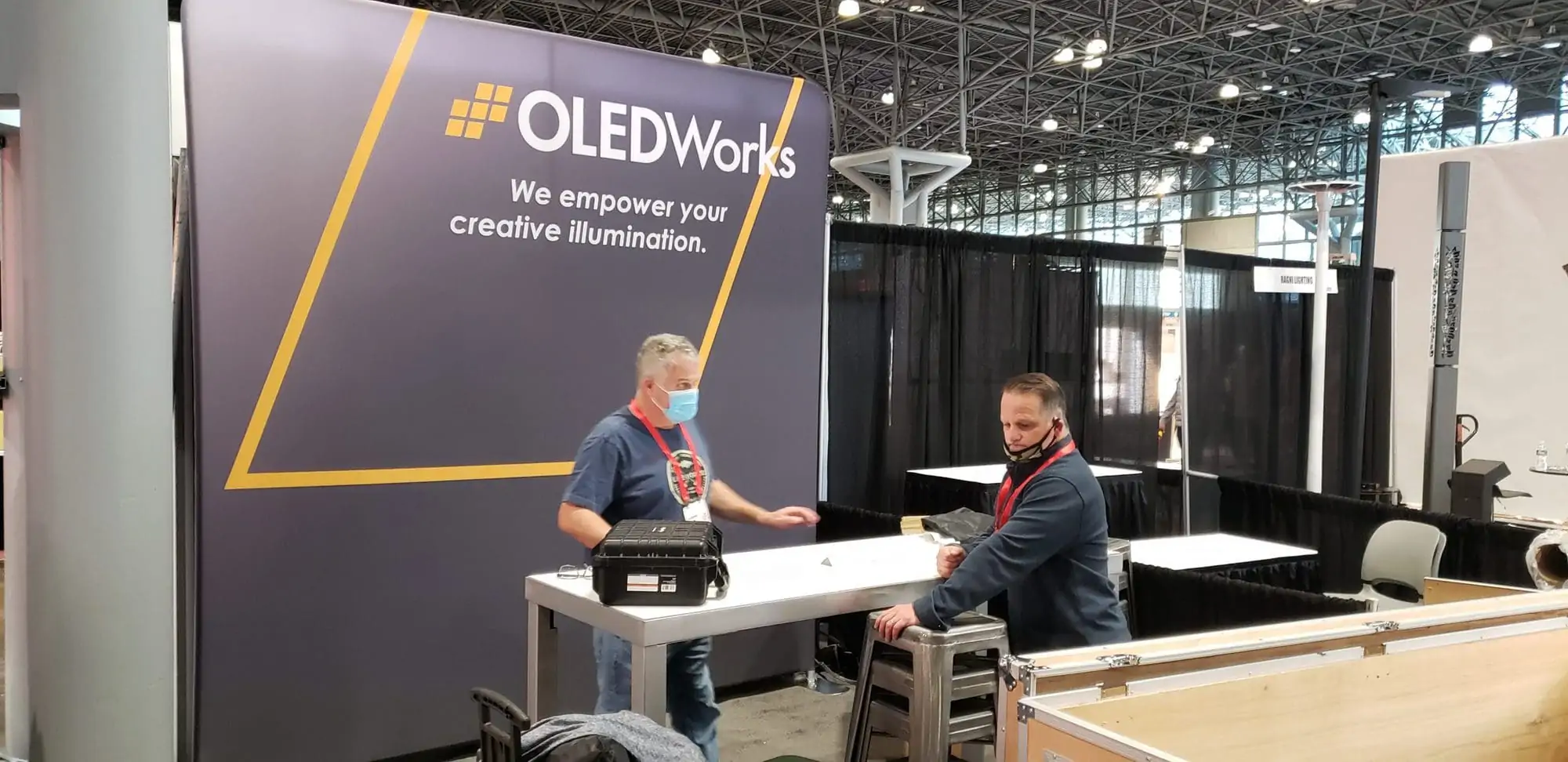 OLEDWorks team setting up booth at LightFair