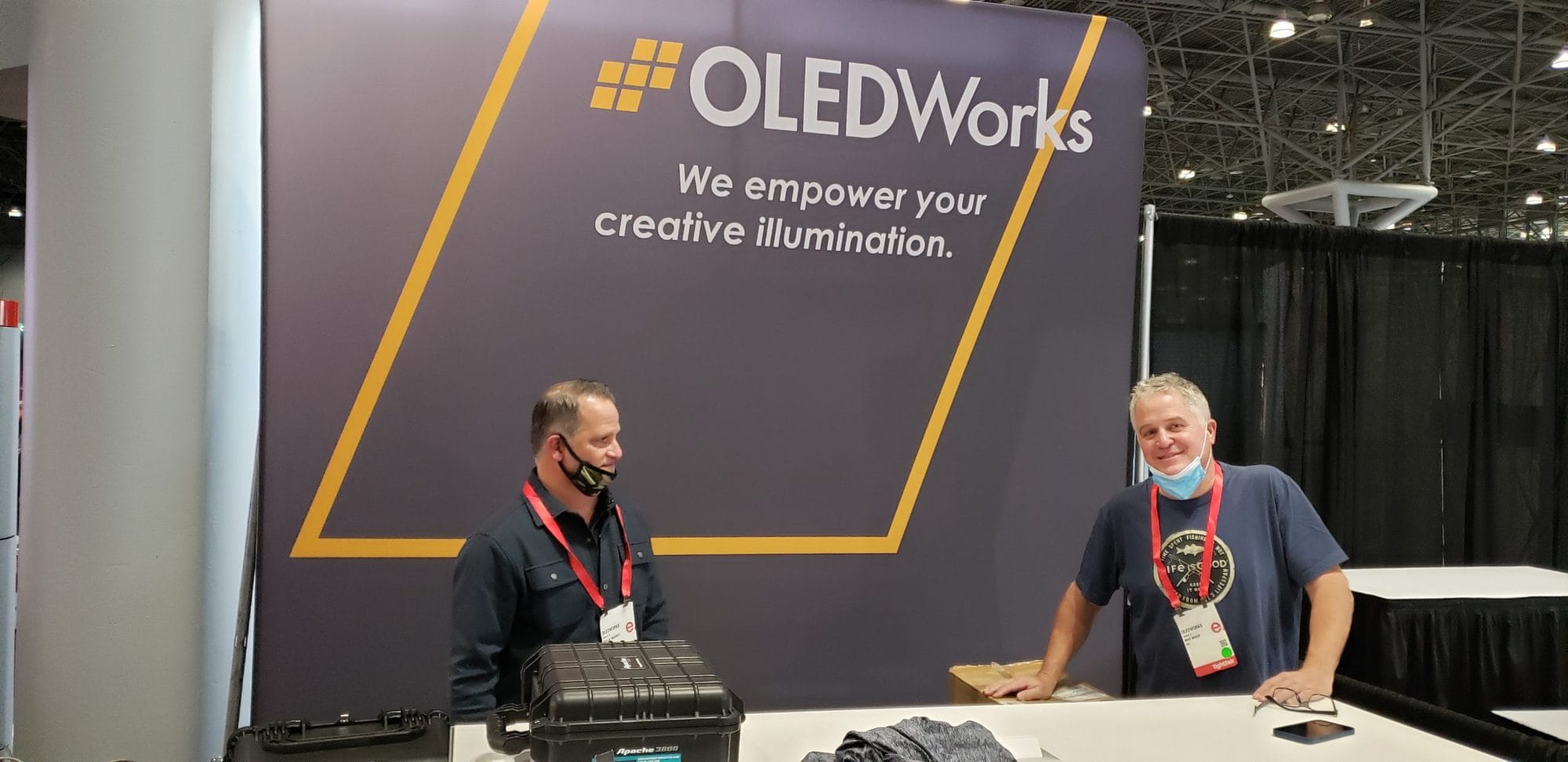 OLEDWorks team setting up booth at LightFair