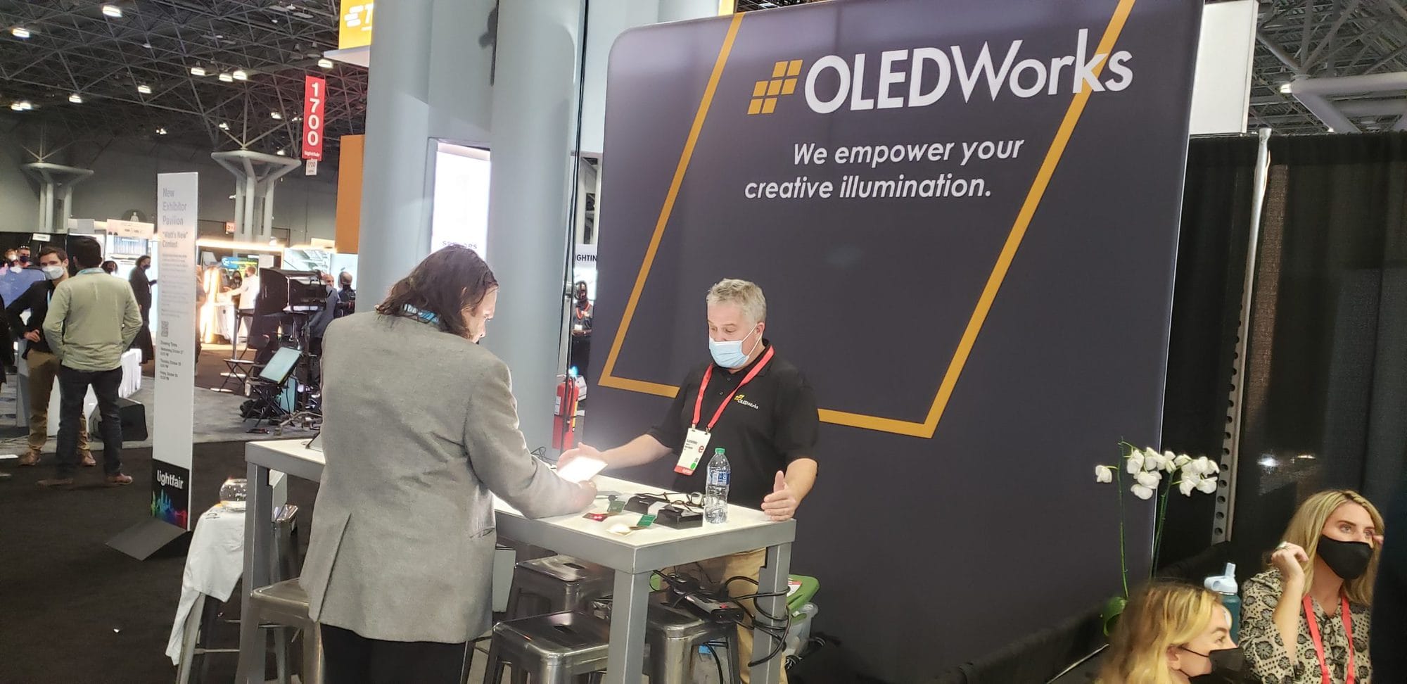 Attendee visits the OLEDWorks booth at LightFair