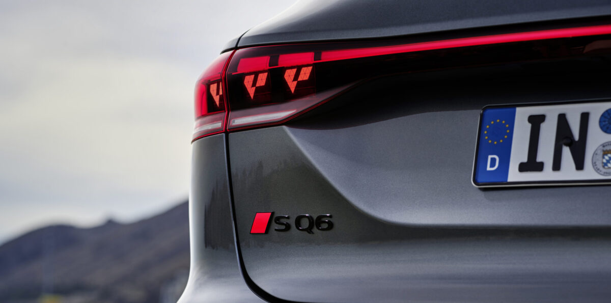 Rear view of grey car with red taillights.